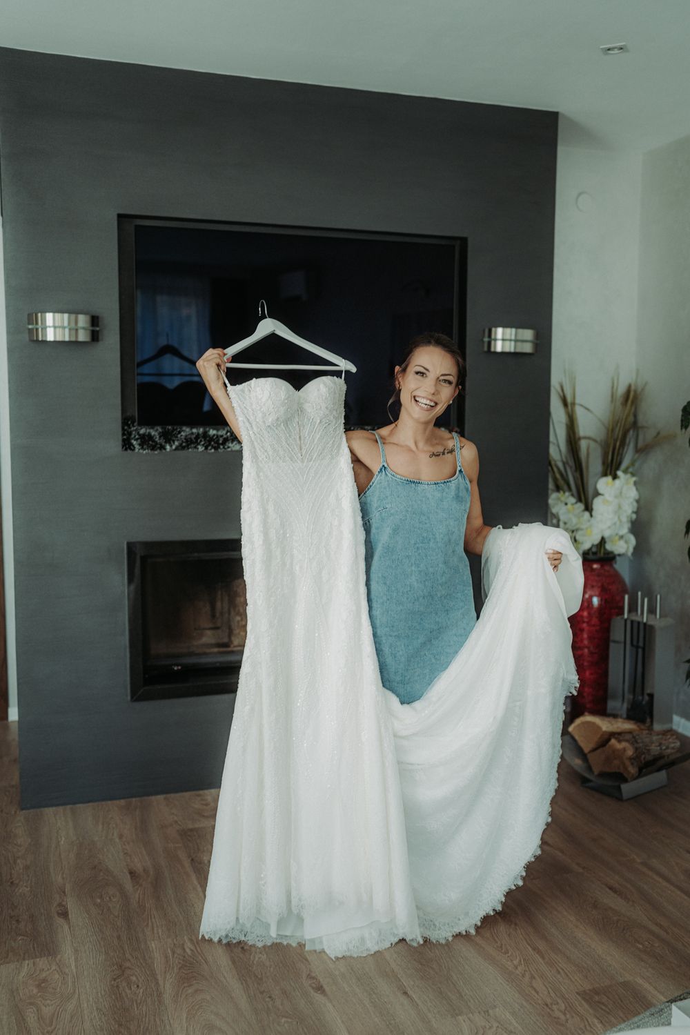White wedding dresses displayed on hangers in a modern interior space.