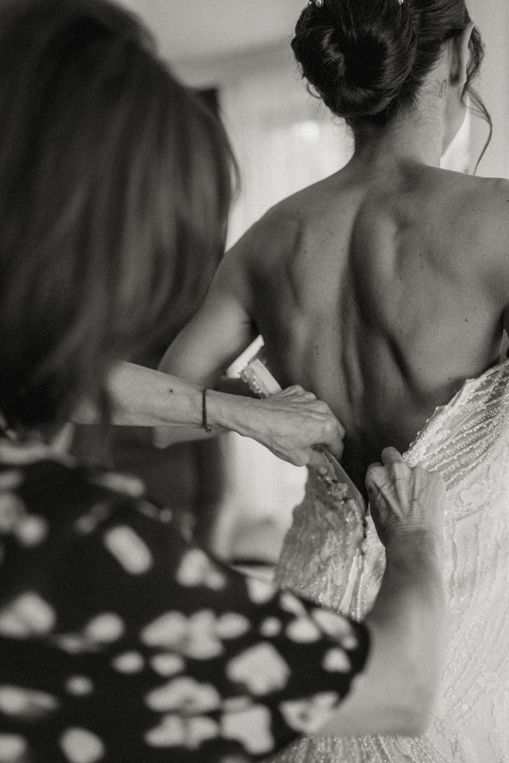 Black and white detail shot of an intricate lace wedding dress back.