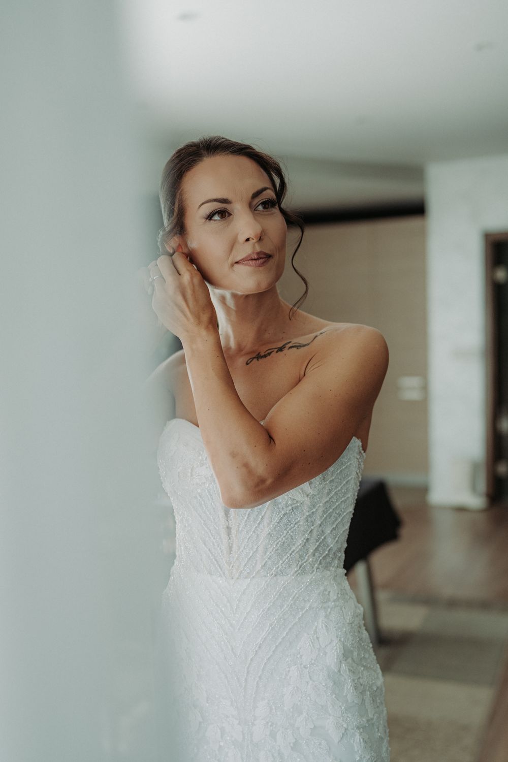 Close-up details of an intricate lace wedding dress with delicate beading and embellishments.