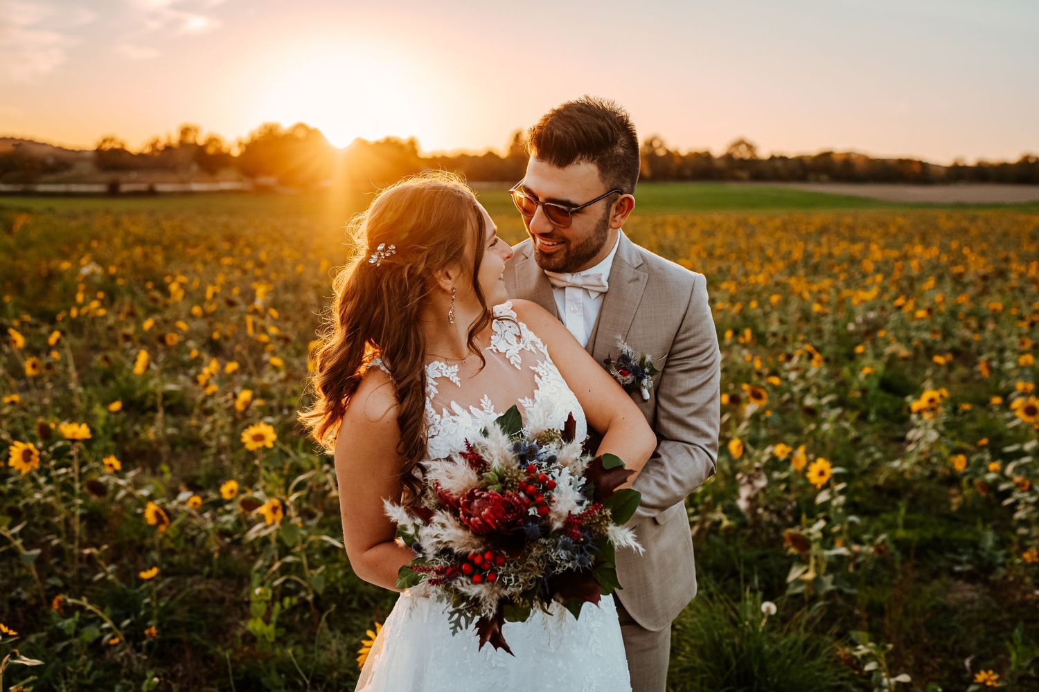 Intimate romantic couple sharing tender kisses in moody lighting with warm orange glow.