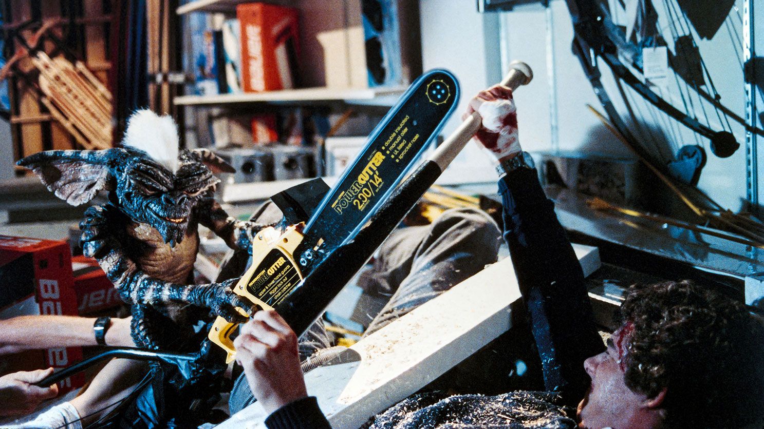 Stripe the Gremlin with chainsaw in a battle with Billy, played by Zach Galligan