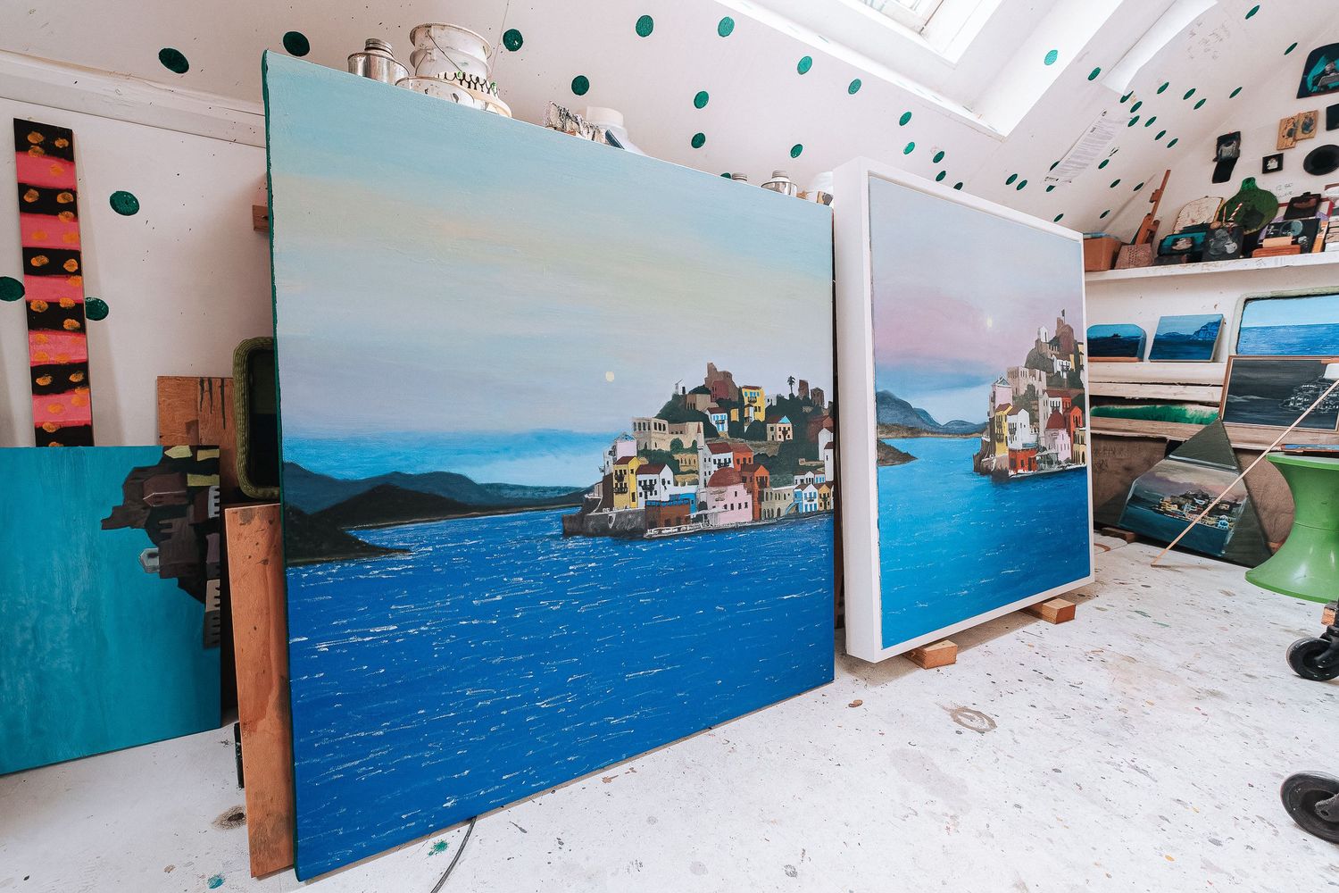 Indoor space with coastal mural spanning walls and hanging decorative elements.