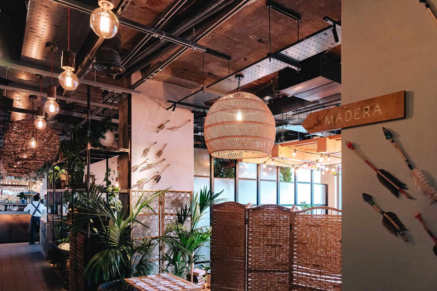 Industrial-style interior with pendant lights, exposed ceiling, and brick accent walls.