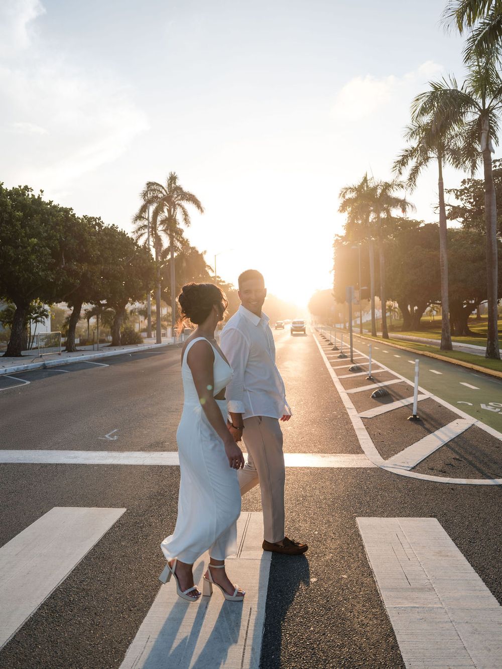 Couple walking across street during golden hour in San Juan Puerto Rico engagement session