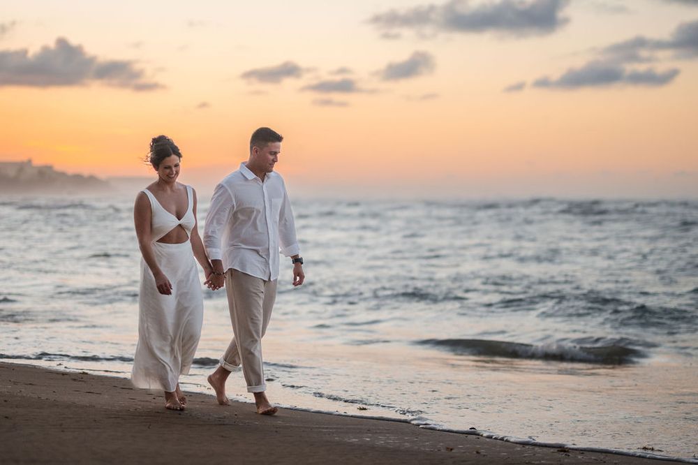 Couple embracing with ocean view during sunset engagement session at El Escambrón