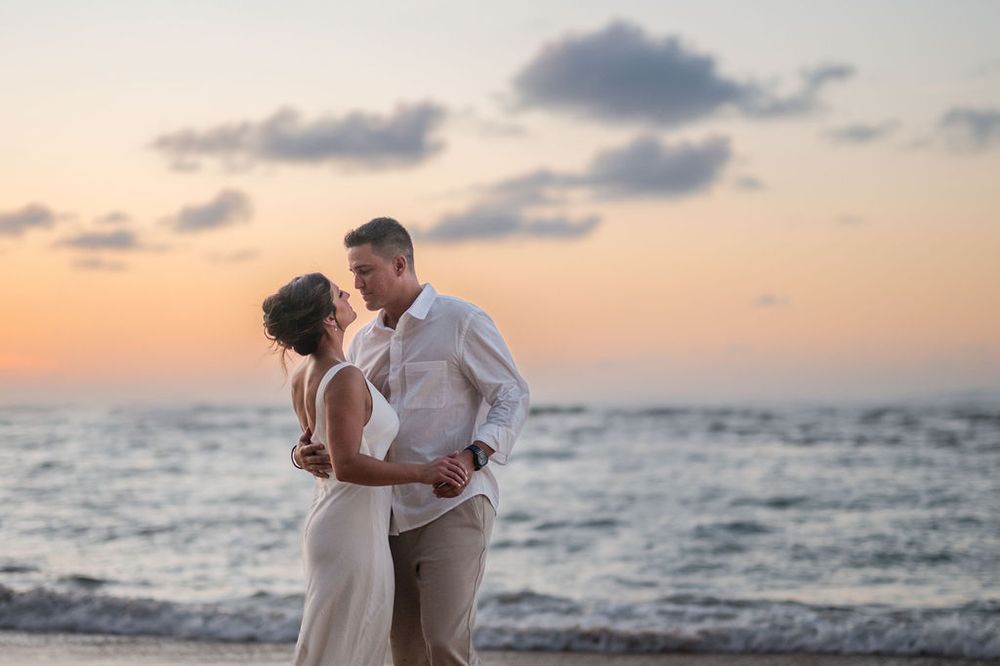 Couple walking along shoreline during golden hour engagement session in San Juan Puerto Rico