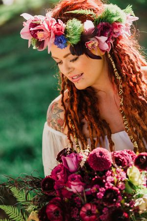 Artistic shots featuring floral crown and burgundy bouquet with ferns and greenery.
