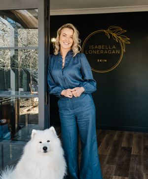 Business interior featuring navy walls, gold signage, and white Samoyed dog.