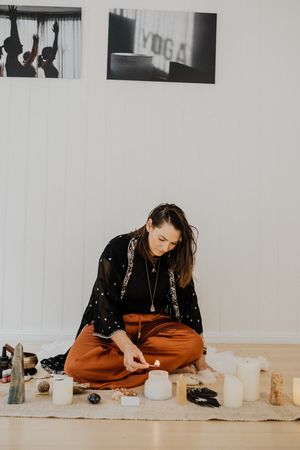 Series showing meditation setup with candles and spiritual objects in minimalist white room.