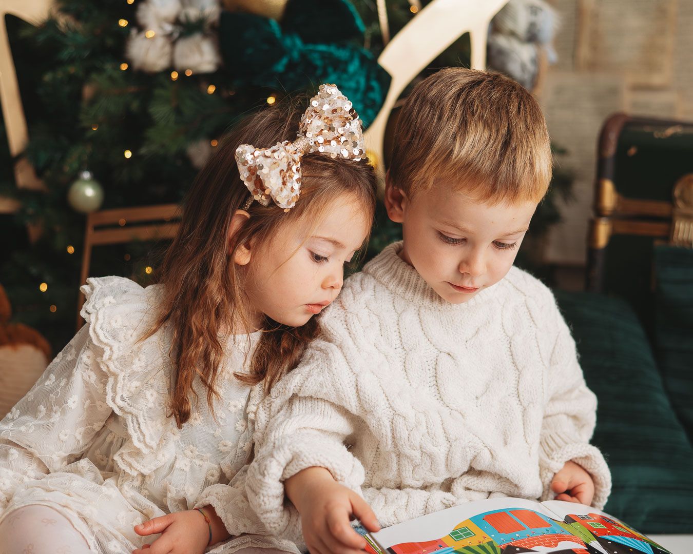A festive holiday photo collage showing a family in matching cream outfits posing by a decorated Christmas tree.