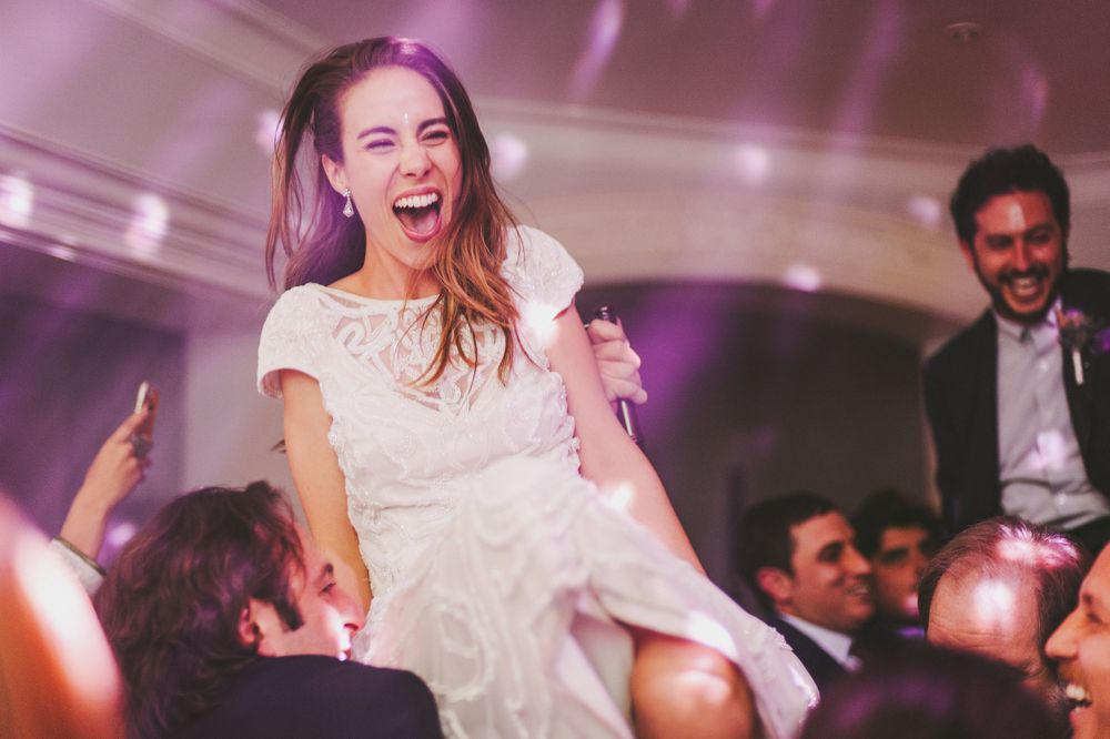 Bride is tossed in the air by friends to celebrate his wedding.