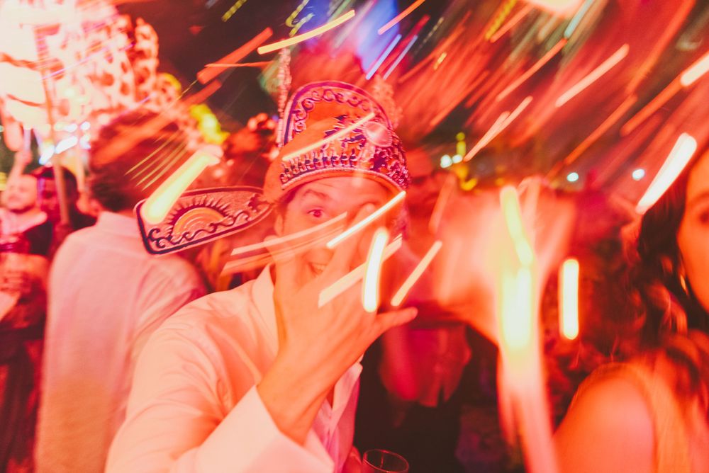 Groom celebrating with guests during wedding party in Colombia.
