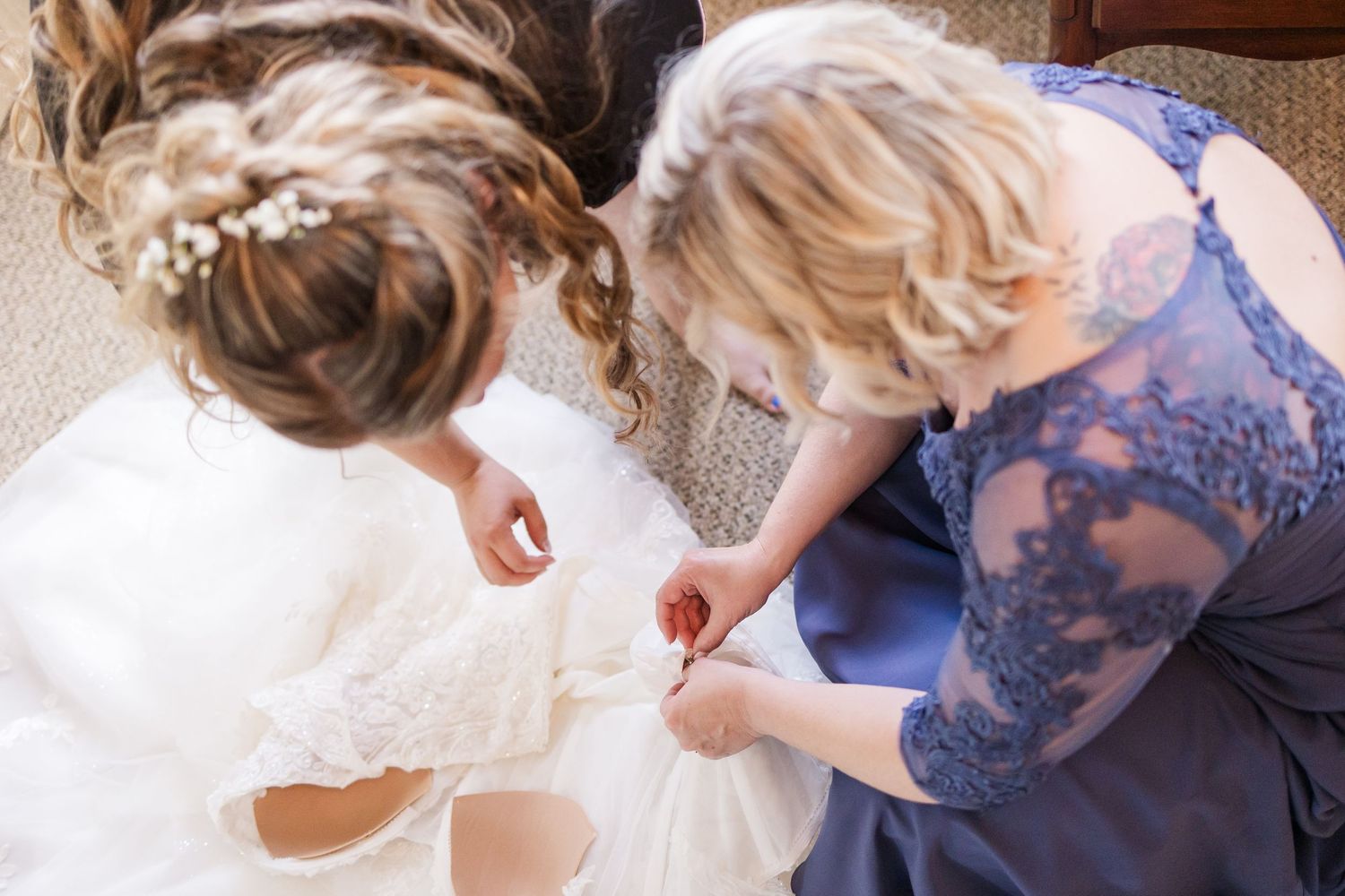 Detail shot of dress preparation with blue lace and white fabric.