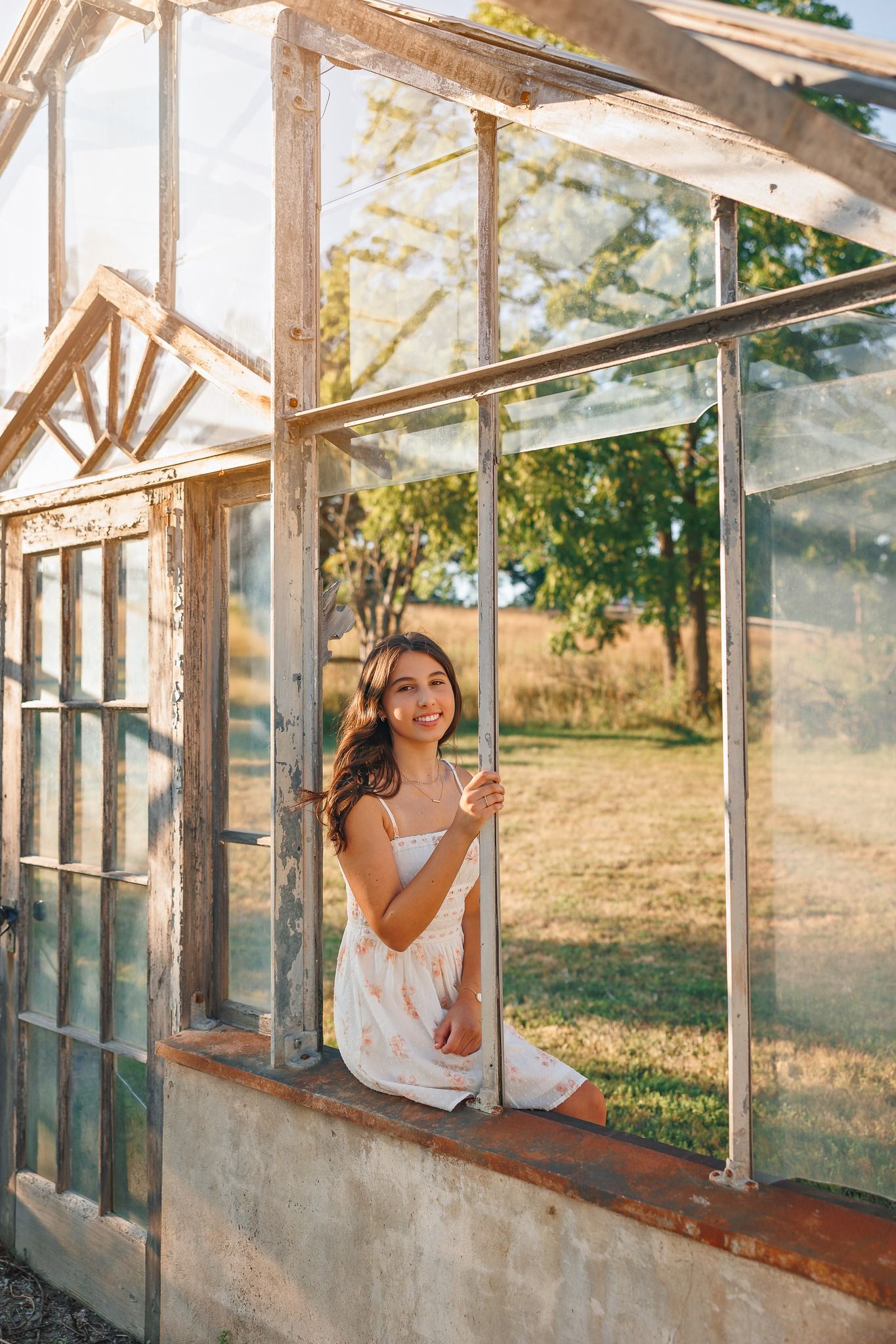 Natural light portraits taken through the windows of an old greenhouse structure.