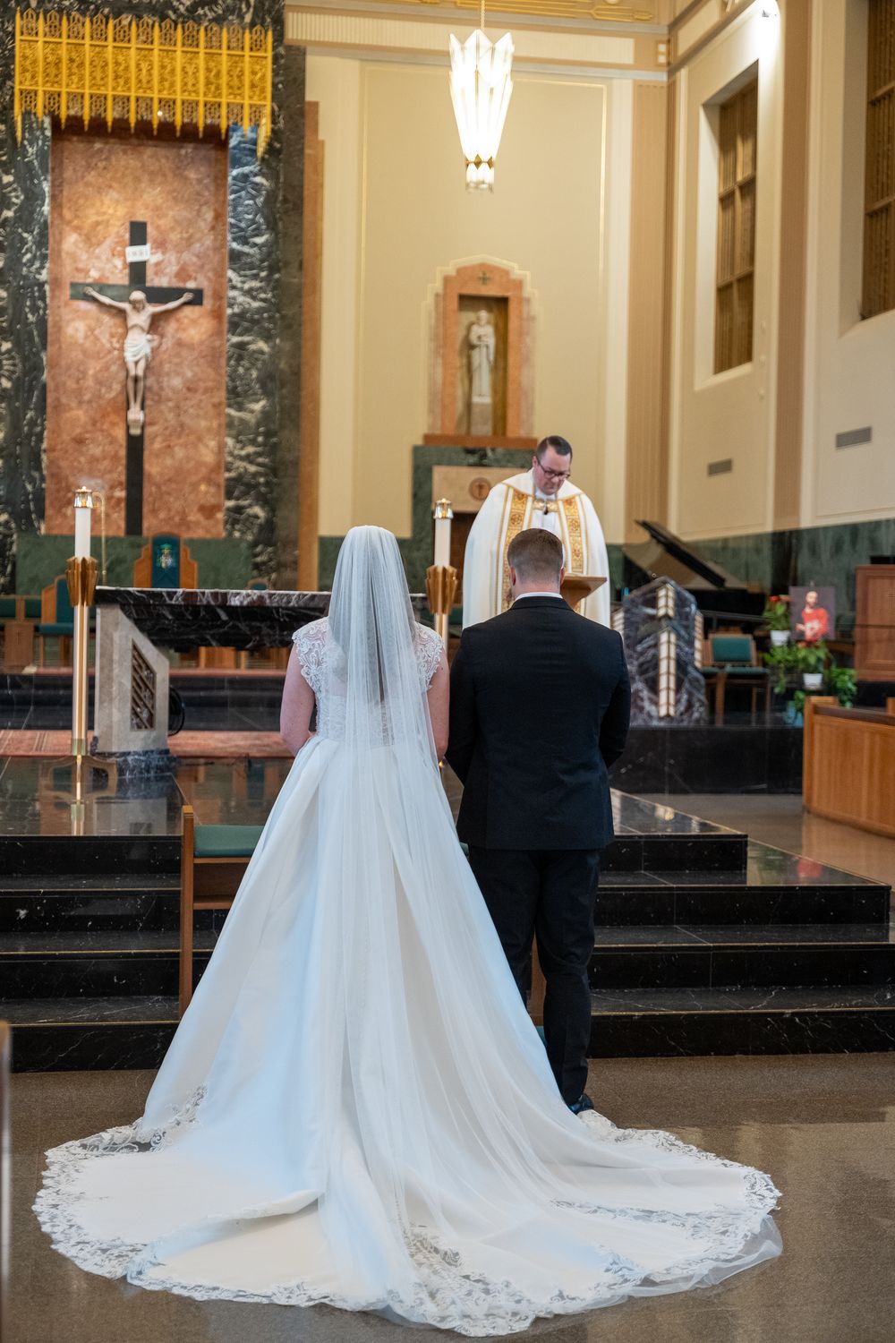A series of wedding photos showing a bride in a long white gown with cathedral veil in a church setting.