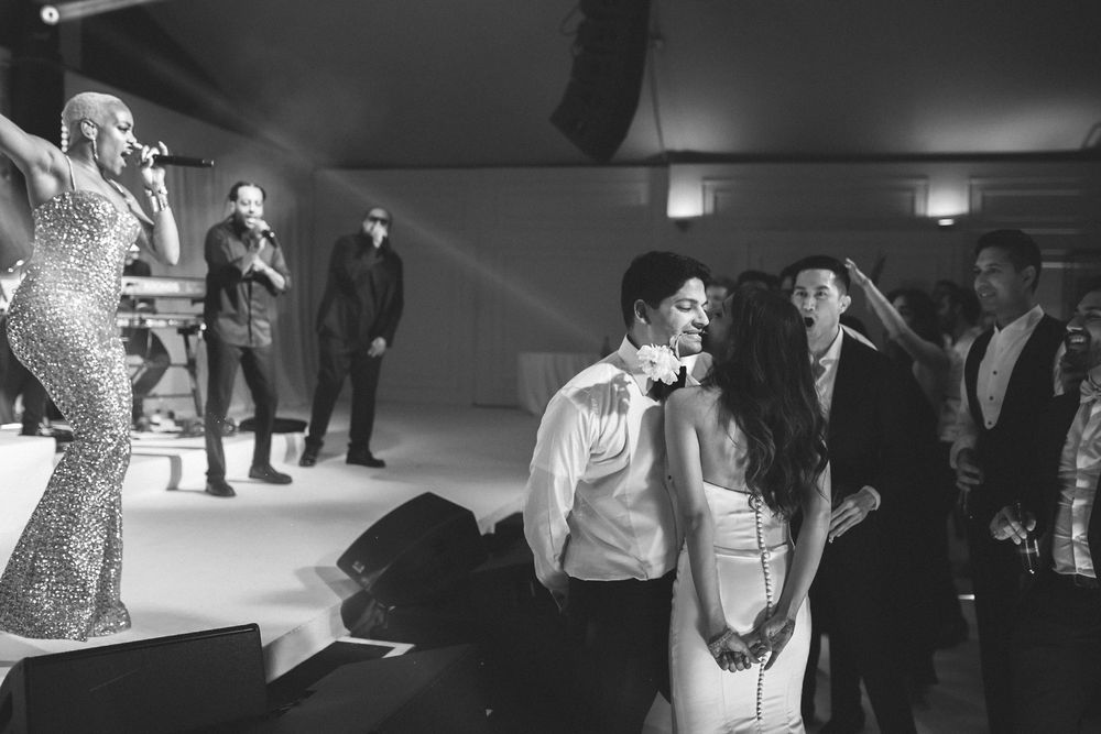 Bride and groom dancing near stage during live concert-style wedding reception in Portugal