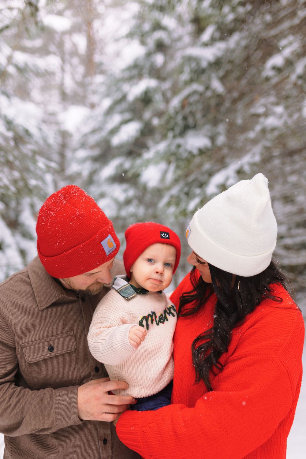 A romantic winter couple sequence shows tender embraces while wearing red and brown coats in a snowy forest setting.