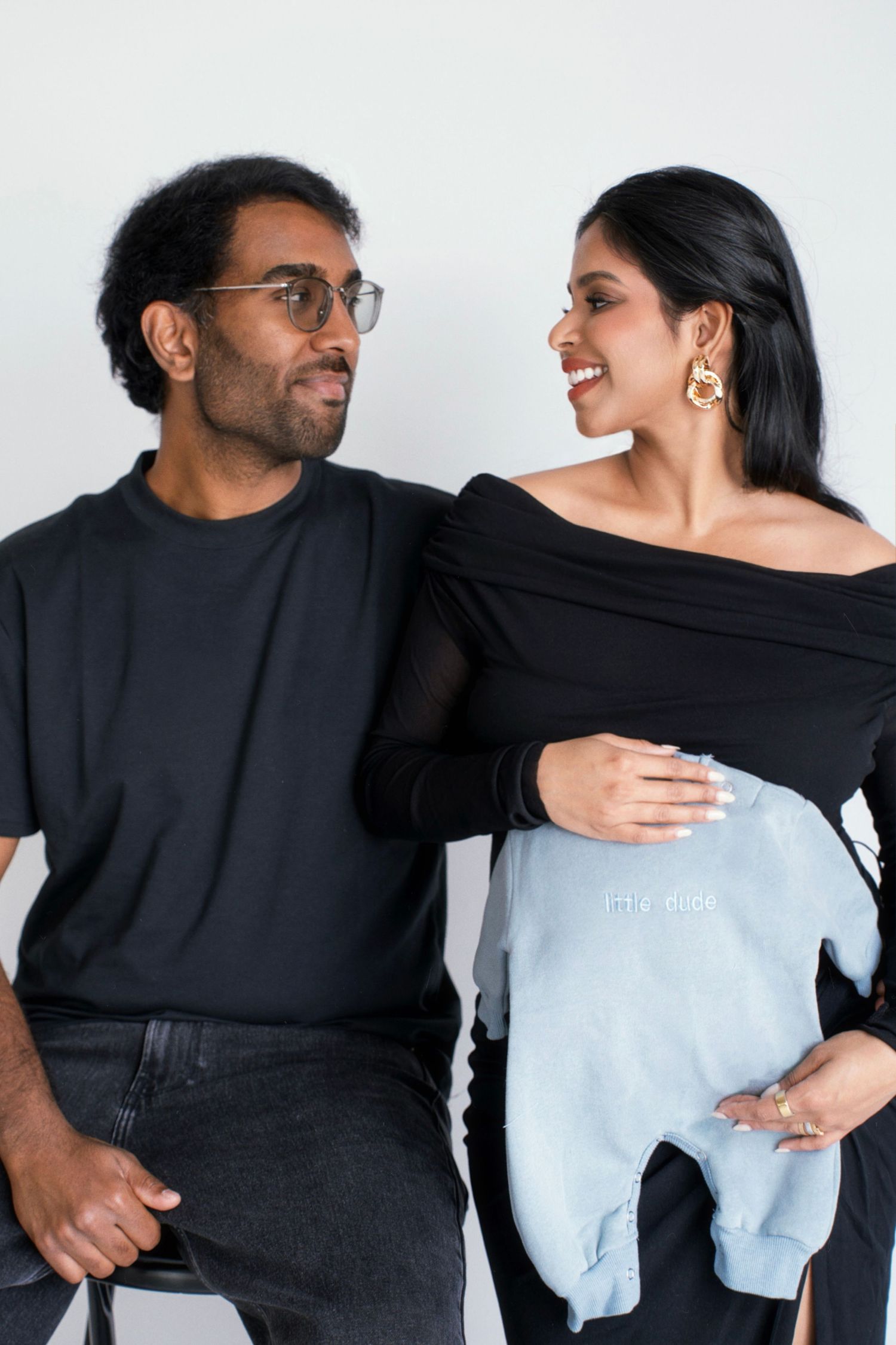 A couple in black and white outfits share playful moments in a series of candid photos.