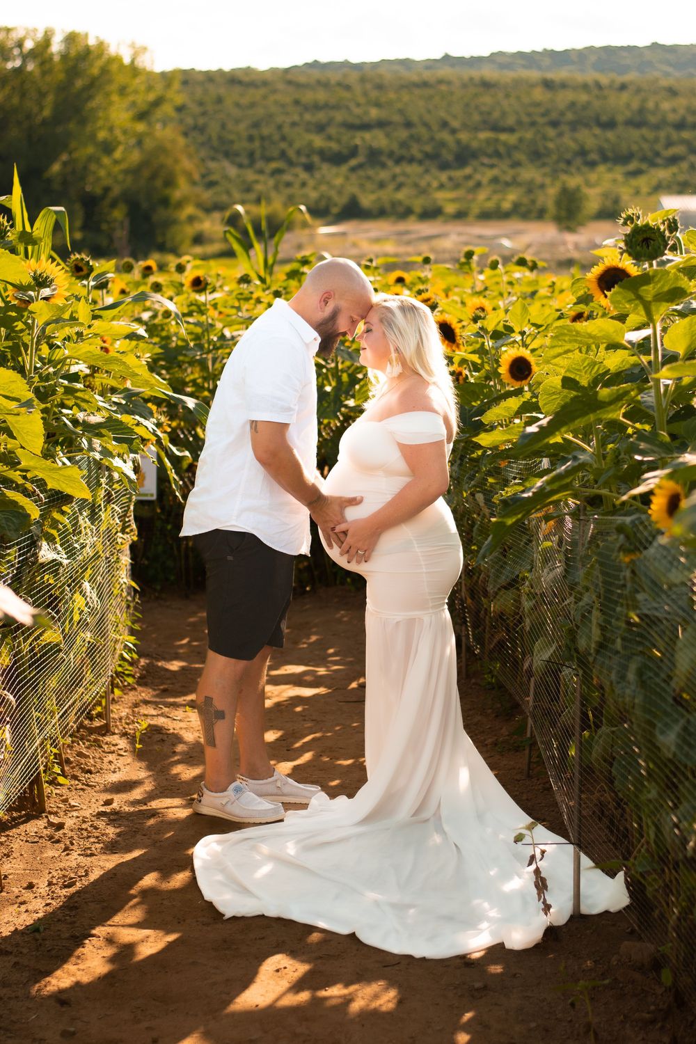 A romantic proposal moment unfolds in a vibrant sunflower field during golden hour.