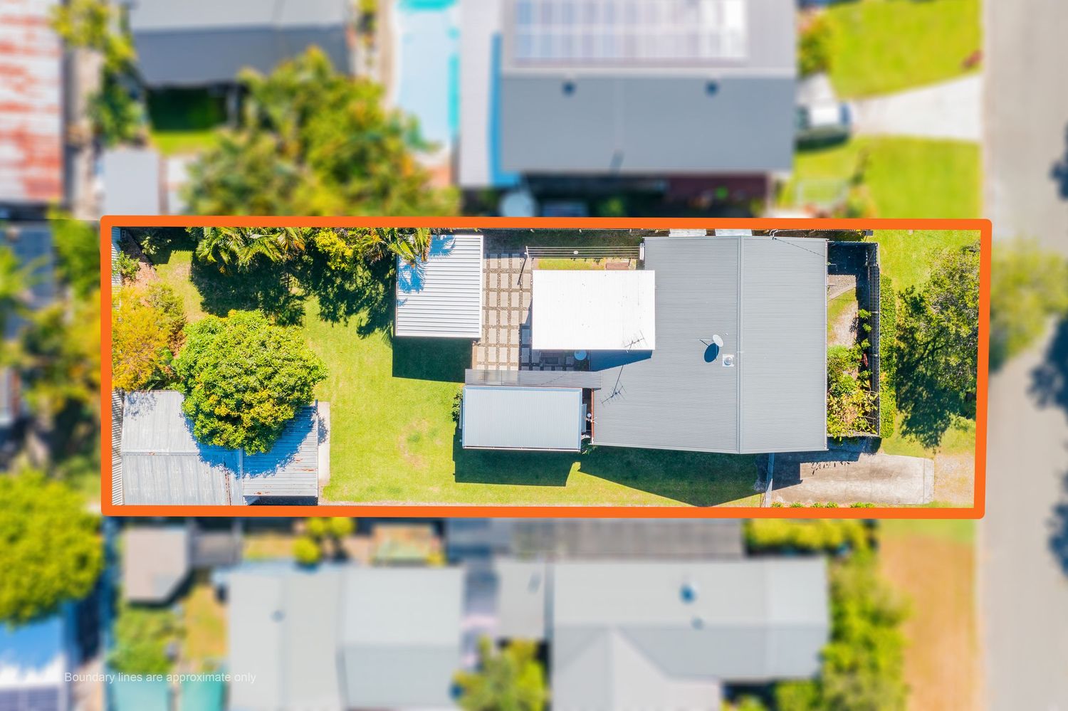 Top-down aerial view of a residential property with orange boundary outline showing land size and layout.