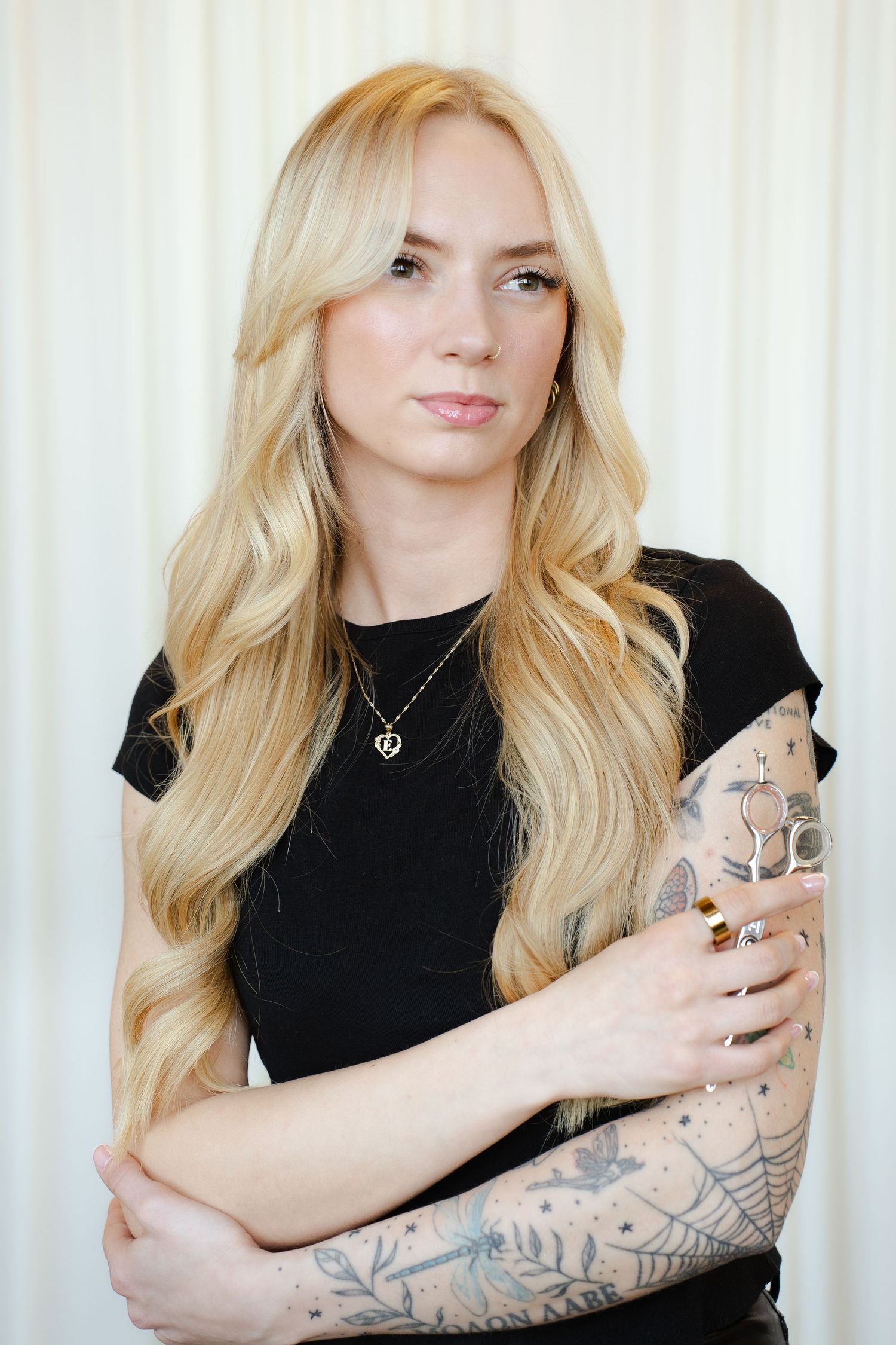 Person in brown pinstripe outfit showing product cards in a photo series against white backdrop.