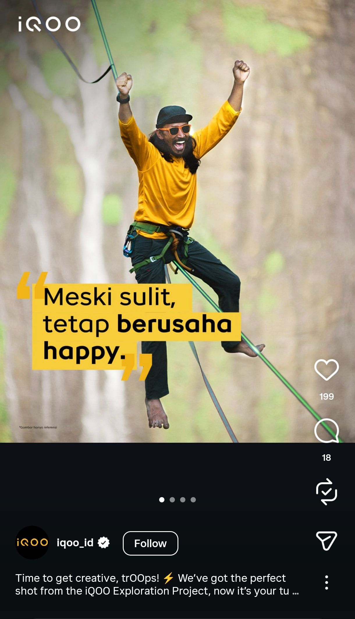 Adventure seeker in yellow jacket rappels down cliff face beside dramatic waterfall while making rock-on hand gestures.
