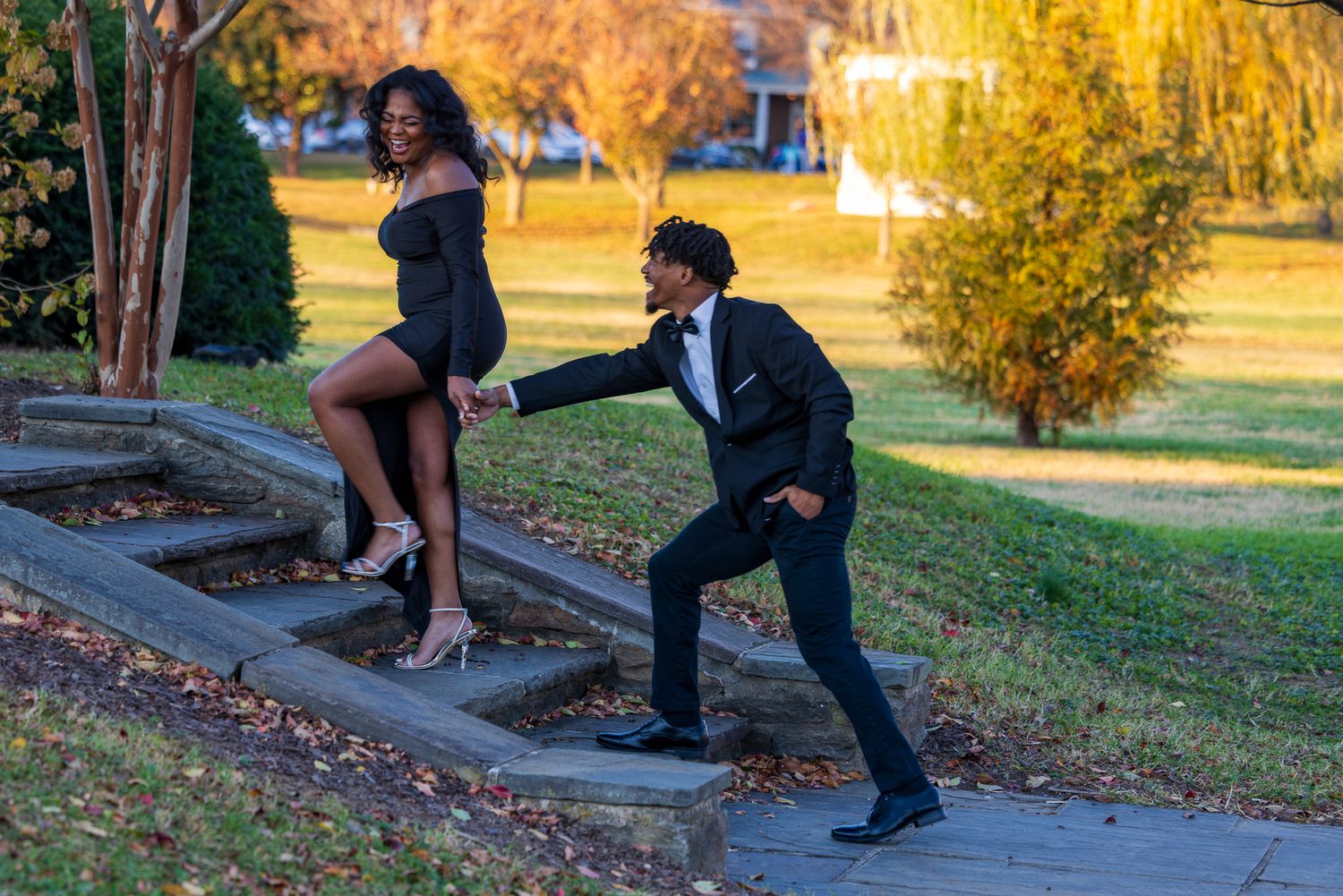 Frederick Maryland Wedding Photographer   - Playful couple in formal wear pose on outdoor stone steps during autumn.