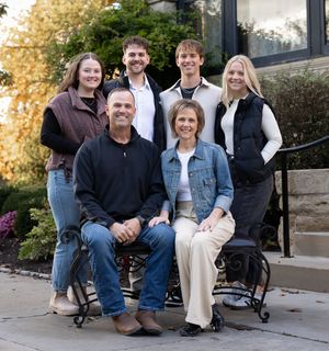 Group sitting casually on outdoor benches during a fall afternoon photoshoot.