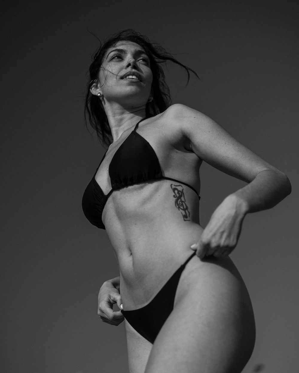 Black and white artistic photo series showing dramatic poses and movements in moody lighting.