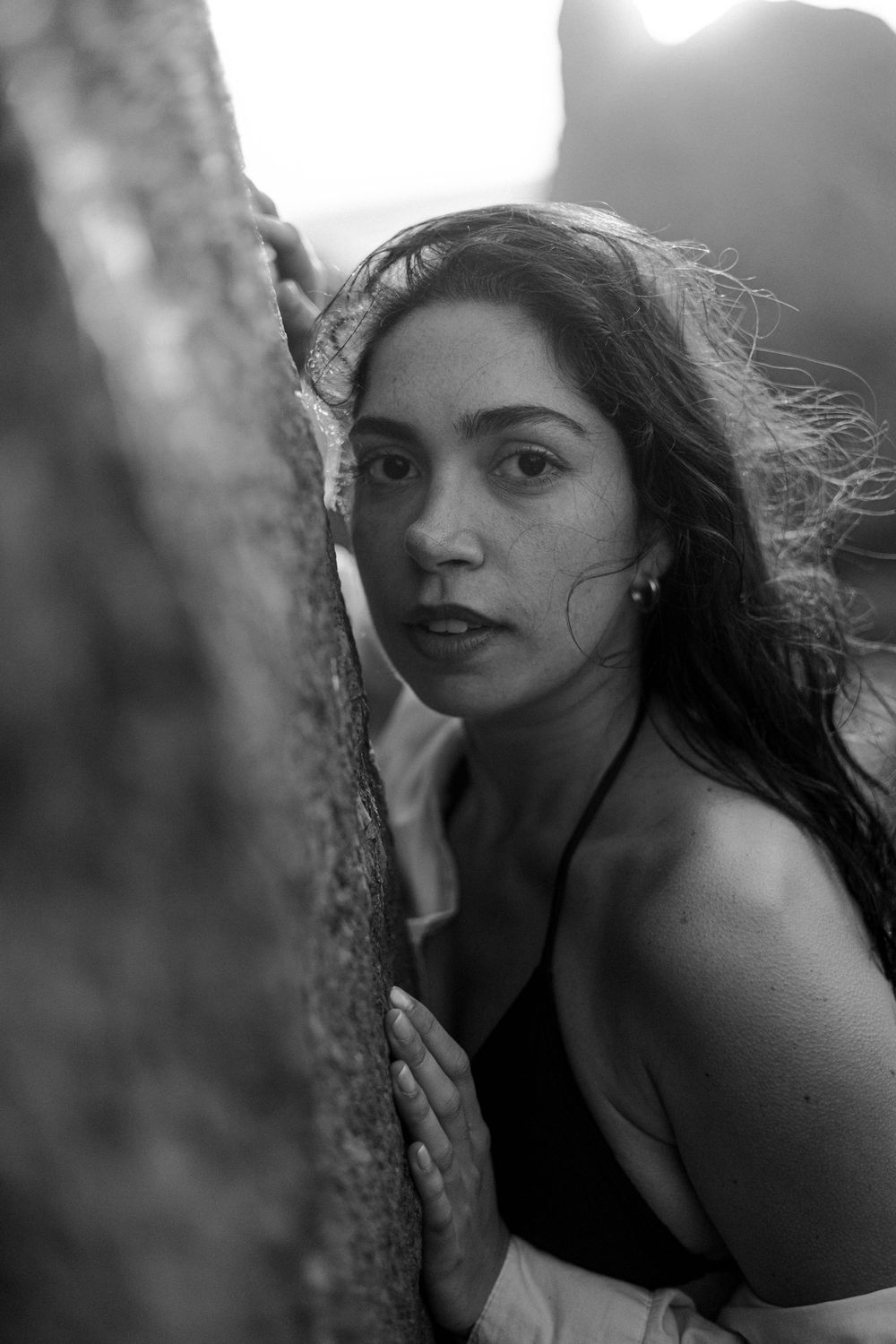 Series of black and white artistic portraits showing a person's silhouette against a natural blurred backdrop.