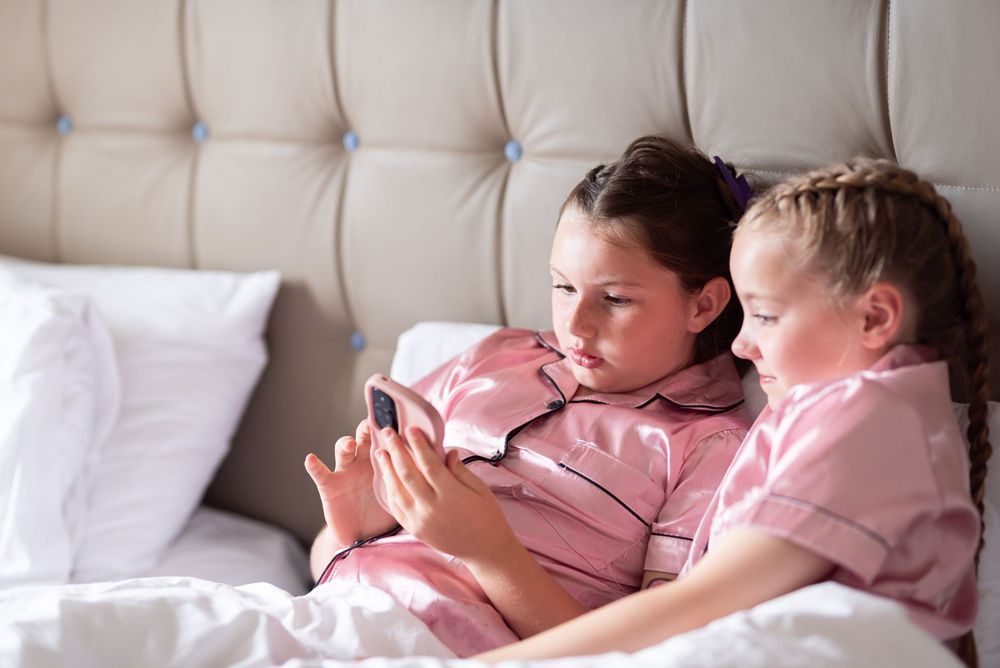 Series of shots showing sleeping figures in pink pajamas resting on a tufted headboard.