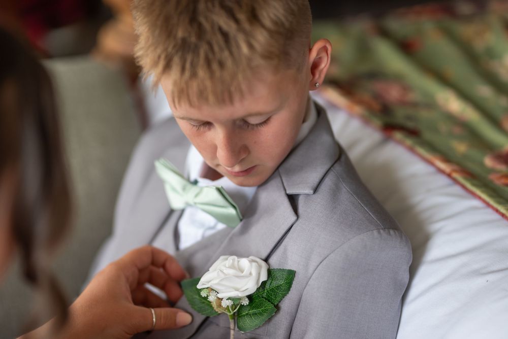 Wedding ceremony in a church setting with grey and white attire.