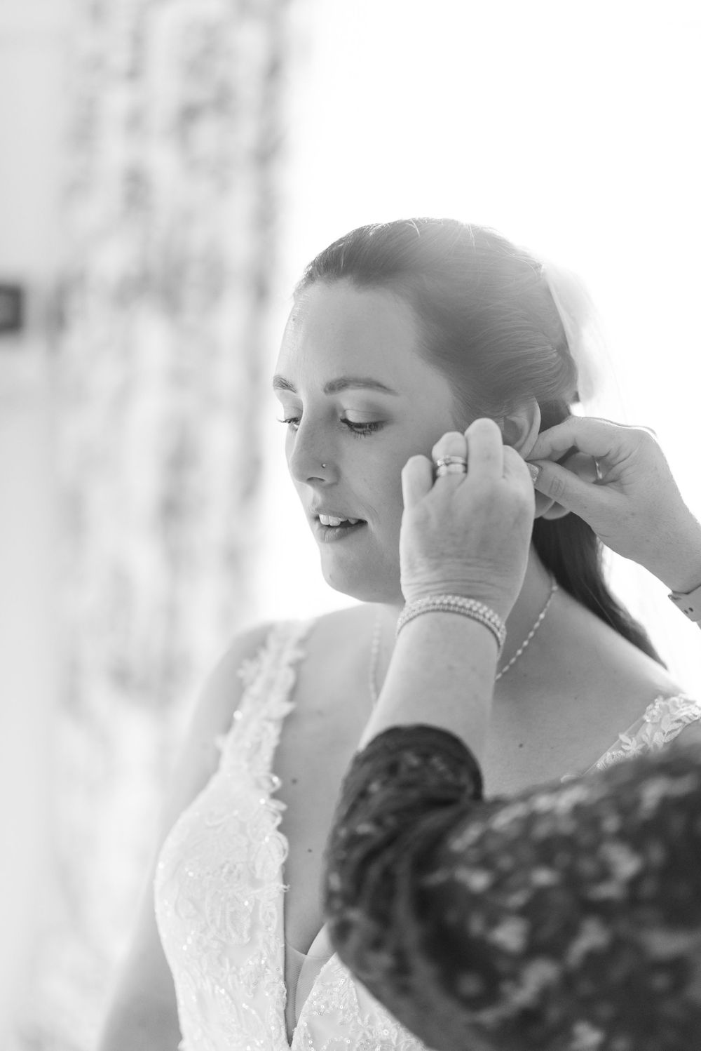 Close-up black and white shots of wedding preparation moments with delicate details.