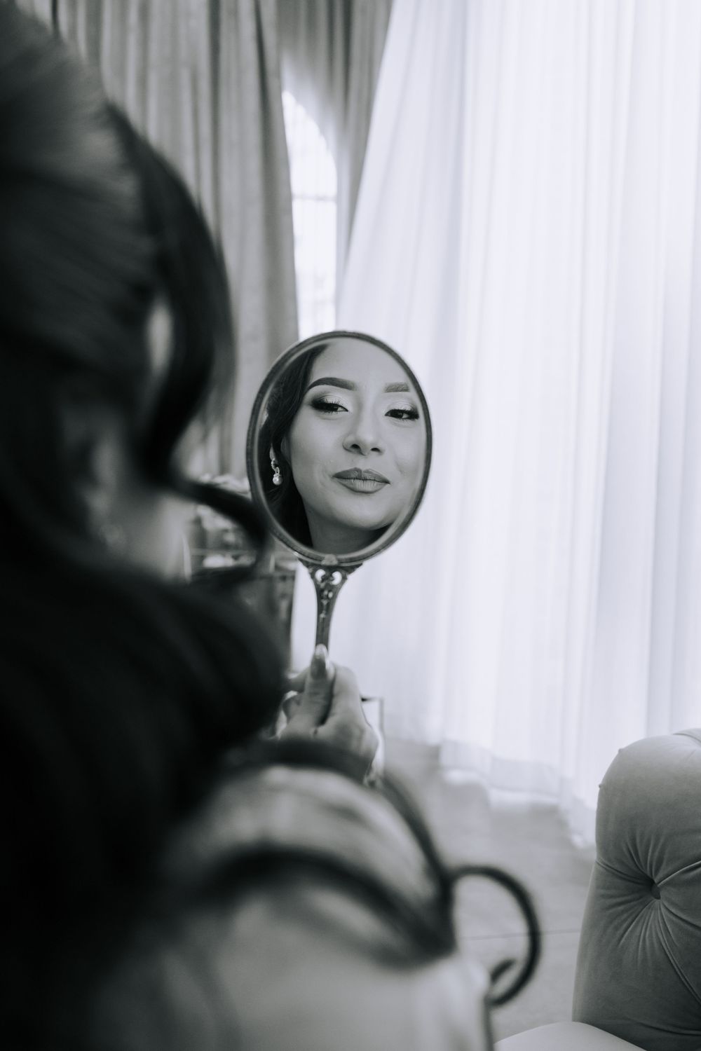 Reflection in a handheld mirror during a glamour photography session.