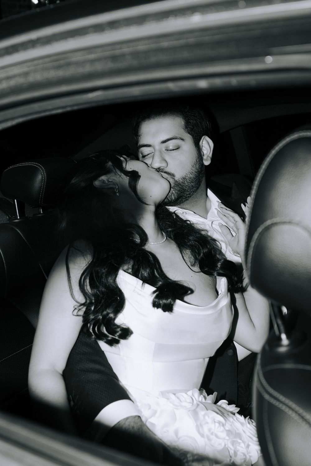 Romantic couple sharing an intimate moment in the back of a car.