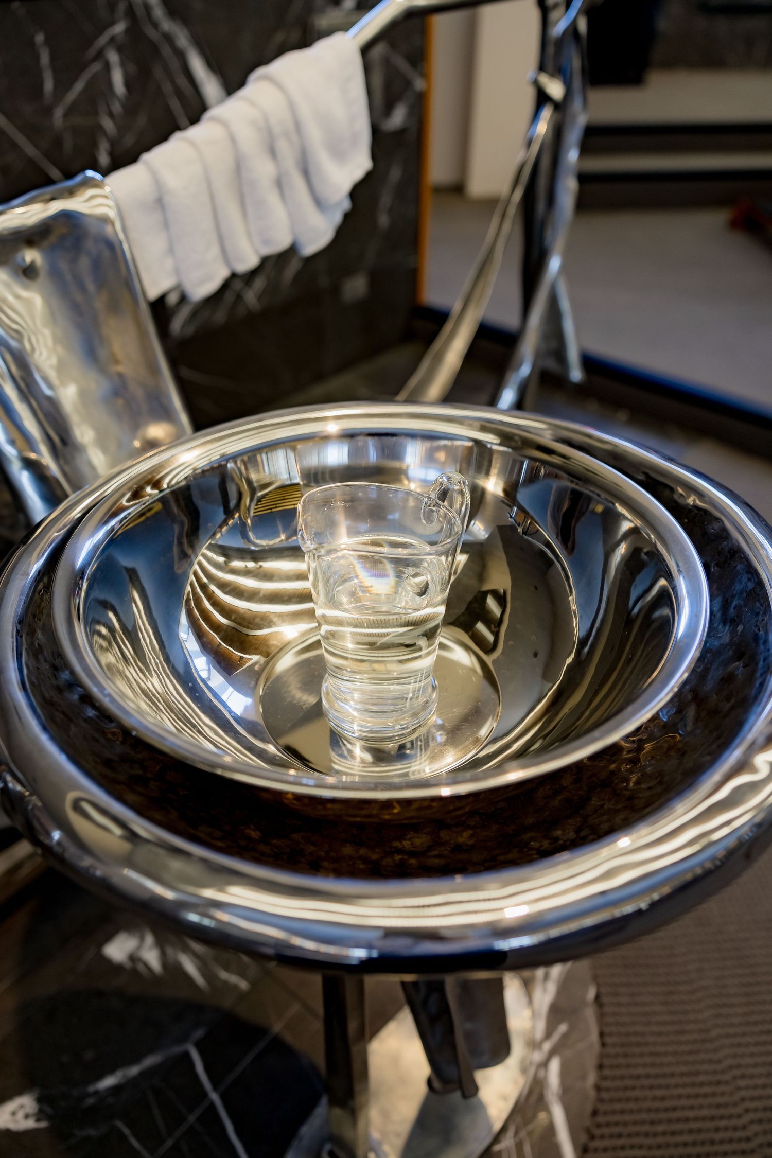 Closeup sequence showing polished silver plate and serving dish being prepared with a shining chrome or metal finish.