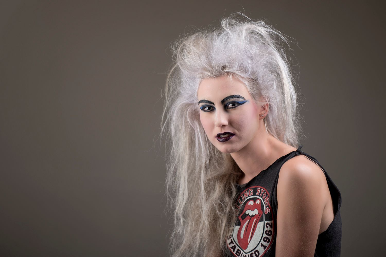 A black and white photo sequence showing expressive poses in dramatic lighting and gothic-inspired styling.