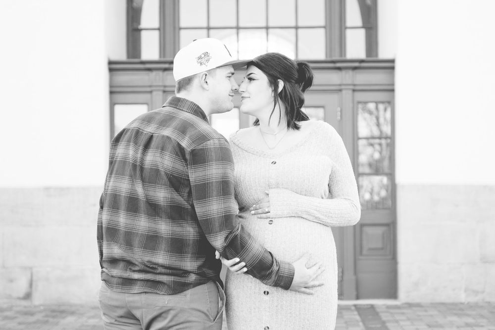 Couple sharing a tender embrace in black and white photo series.