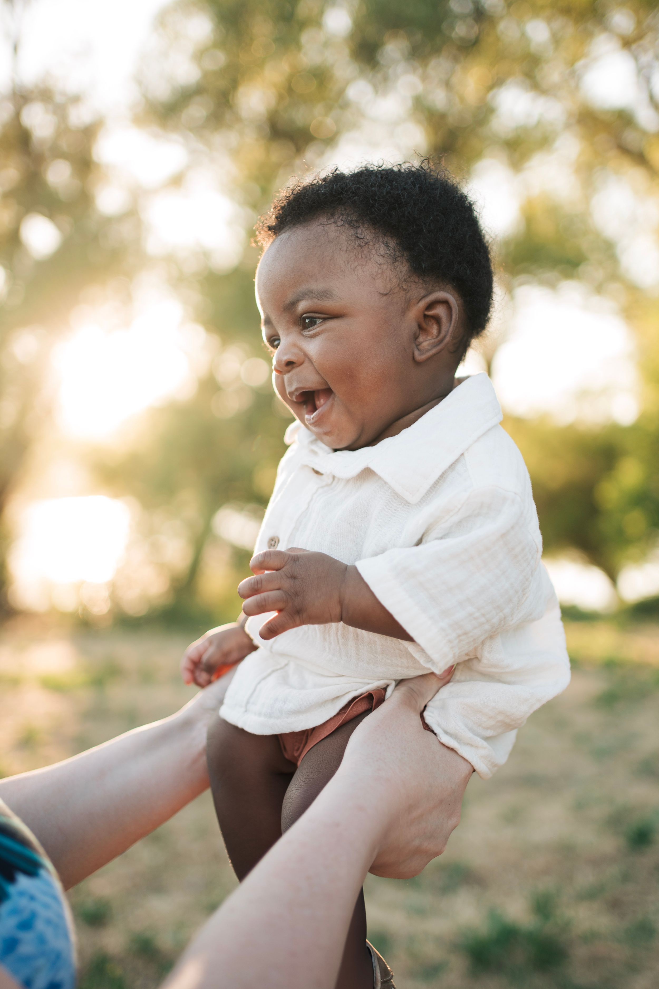 A baby boy in the sunset being held up by mom in vacaville for baby pictures in solano county