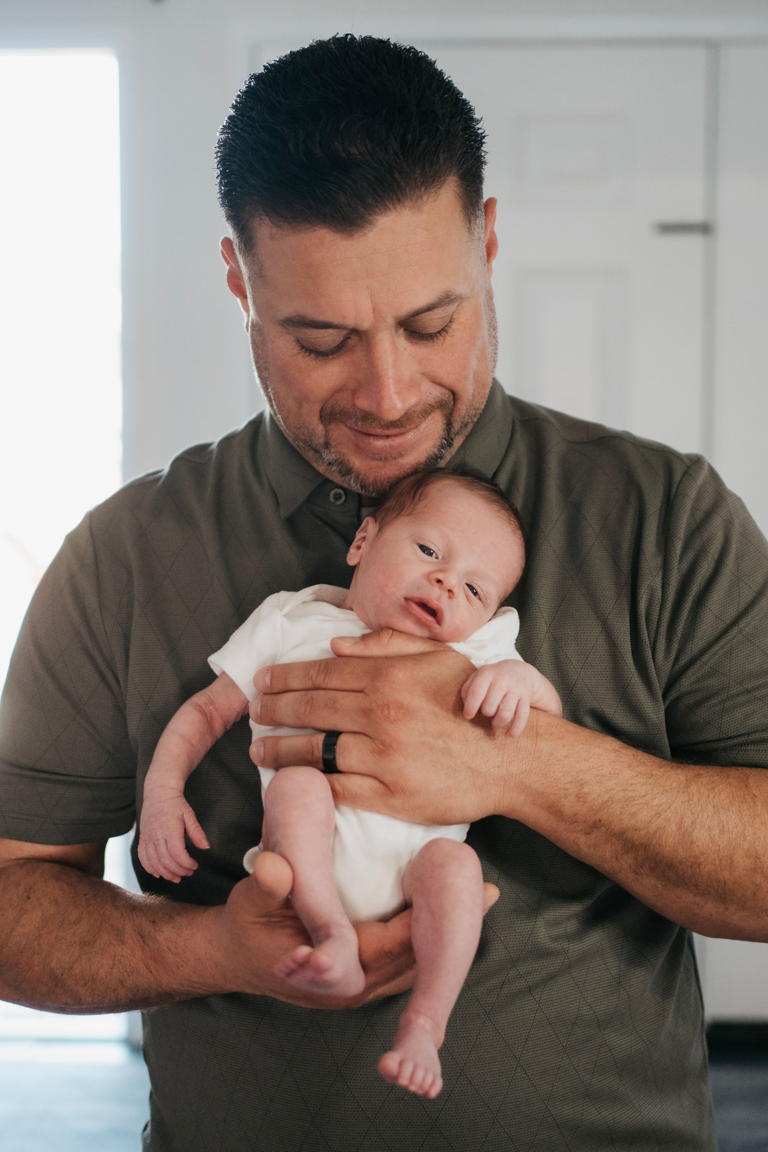A dad with his brand new baby boy for newborn photogrpahy in the bay area