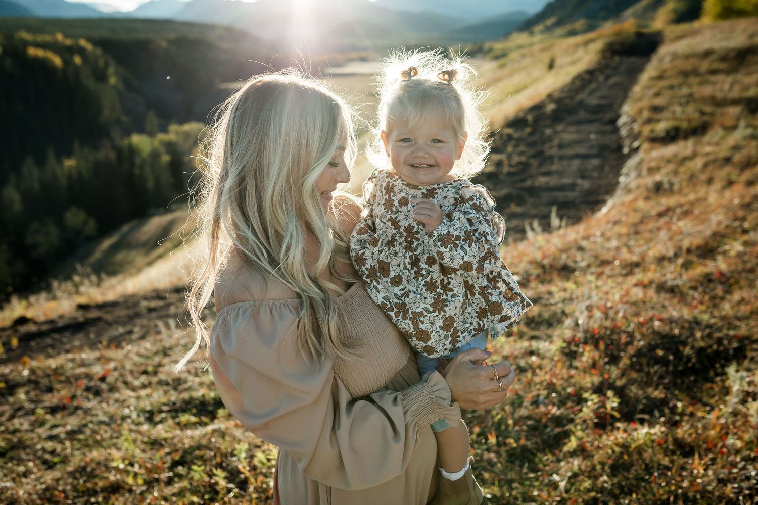 Motherhood moment during fall family photos at golden hour in Kananaskis Mountains by Love & Sunshine Photography.