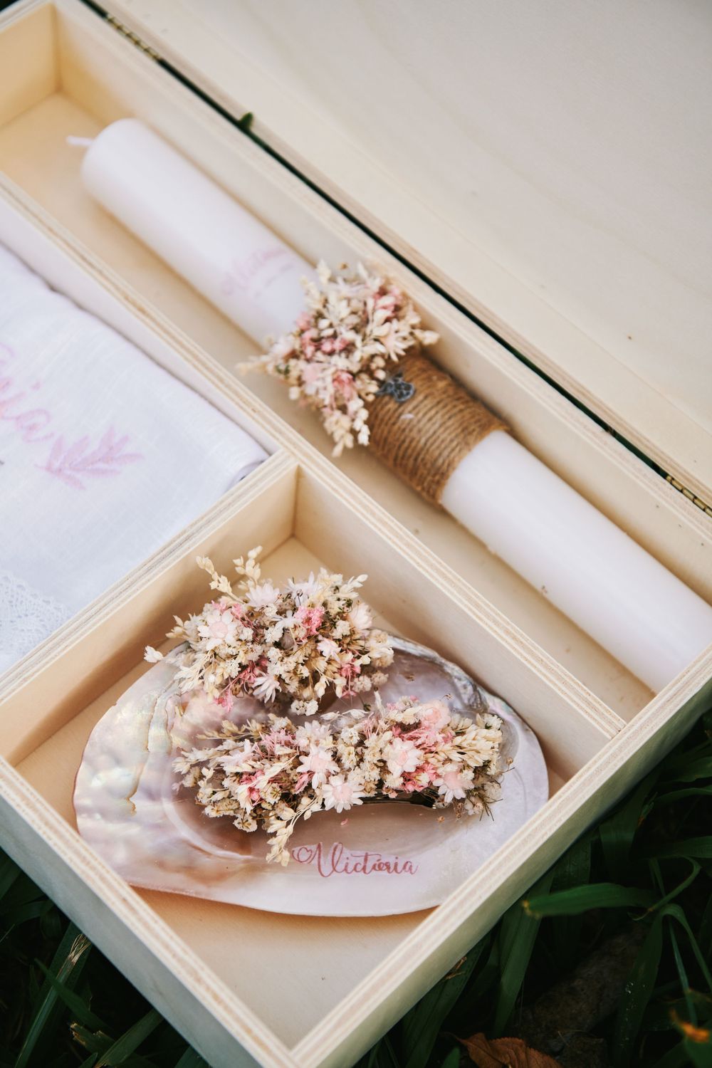 Baptism keepsake box containing a white candle, embroidered cloth, and floral shell decoration named Victoria.