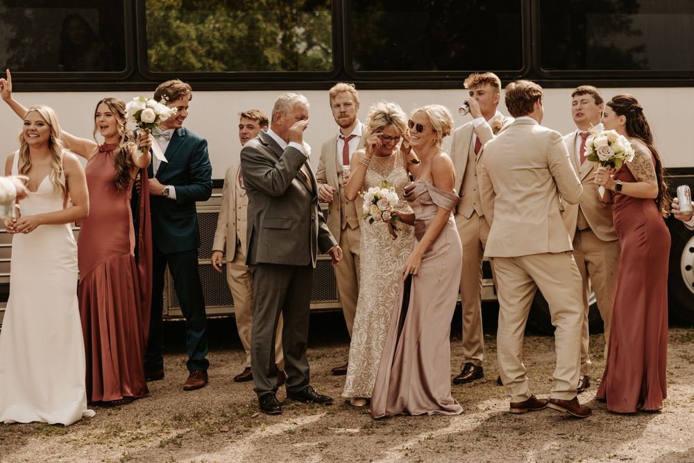 Wedding party in dusty rose and beige attire poses together for group photos.