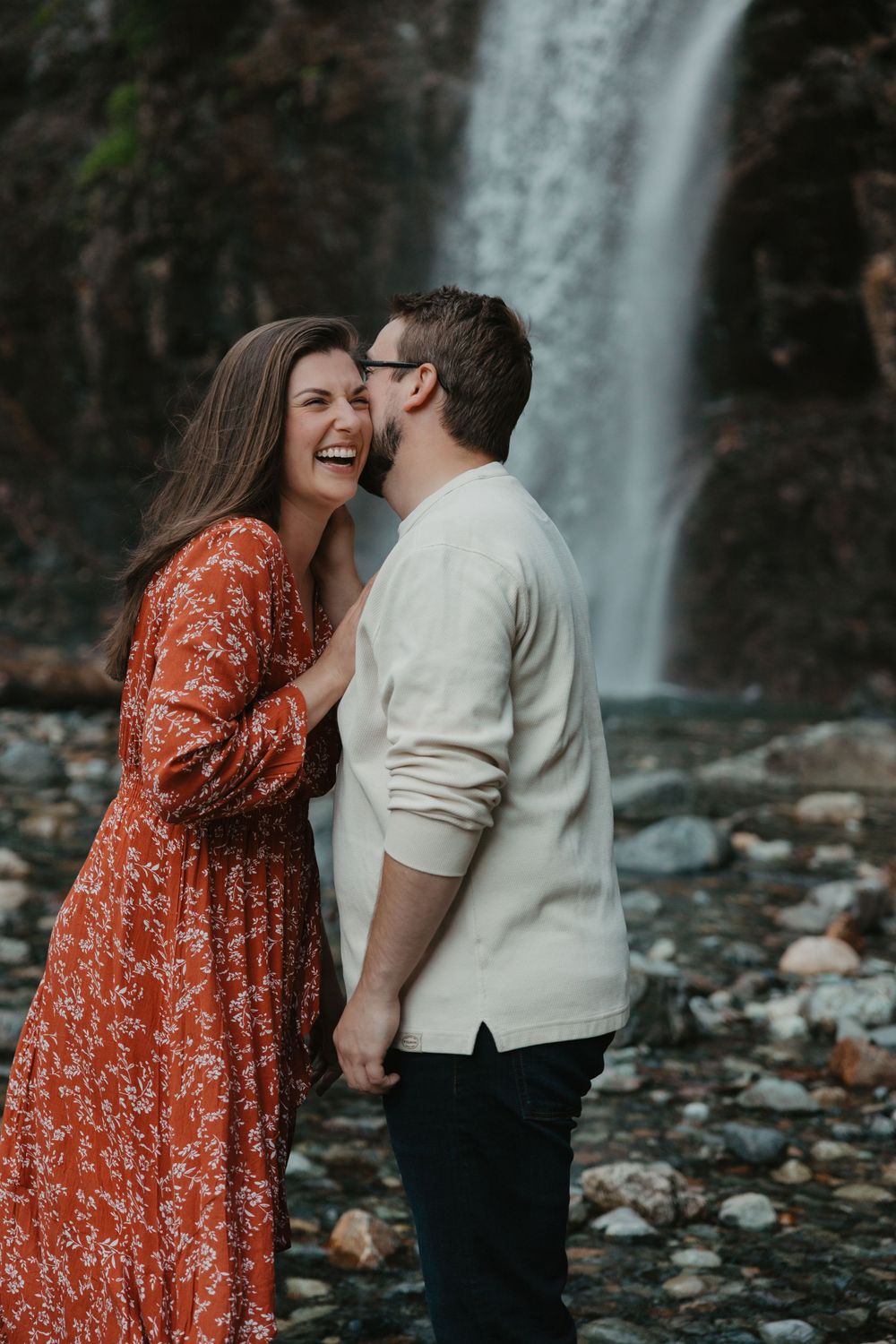 Couple holding hands at waterfall| engagement photography