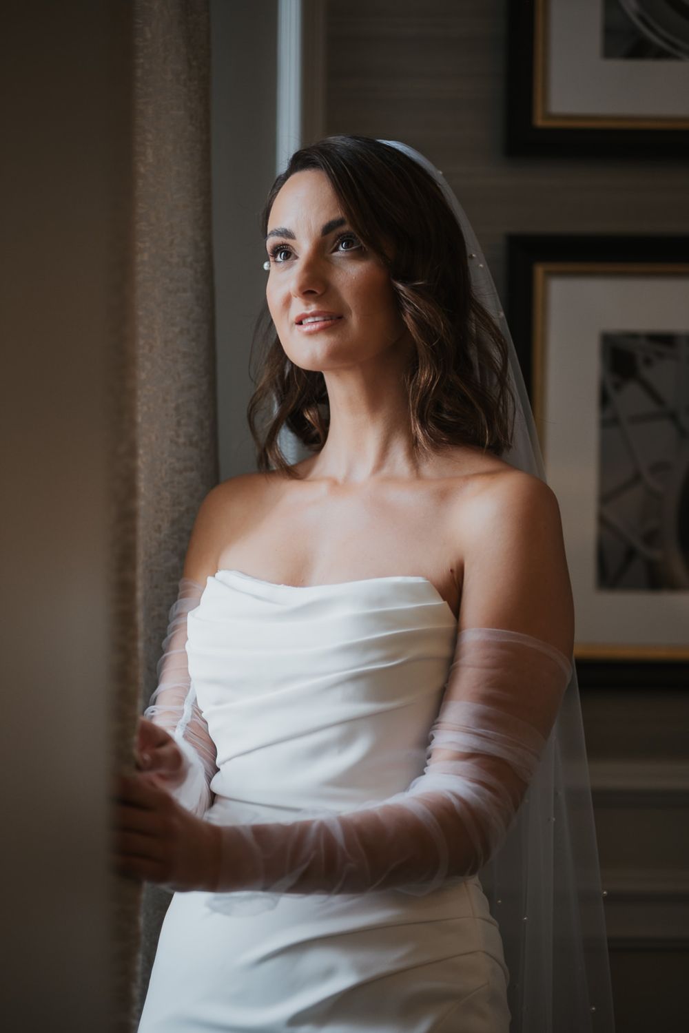A series of elegant bridal portraits showing a figure in a classic white off-shoulder wedding dress against a soft interior backdrop.