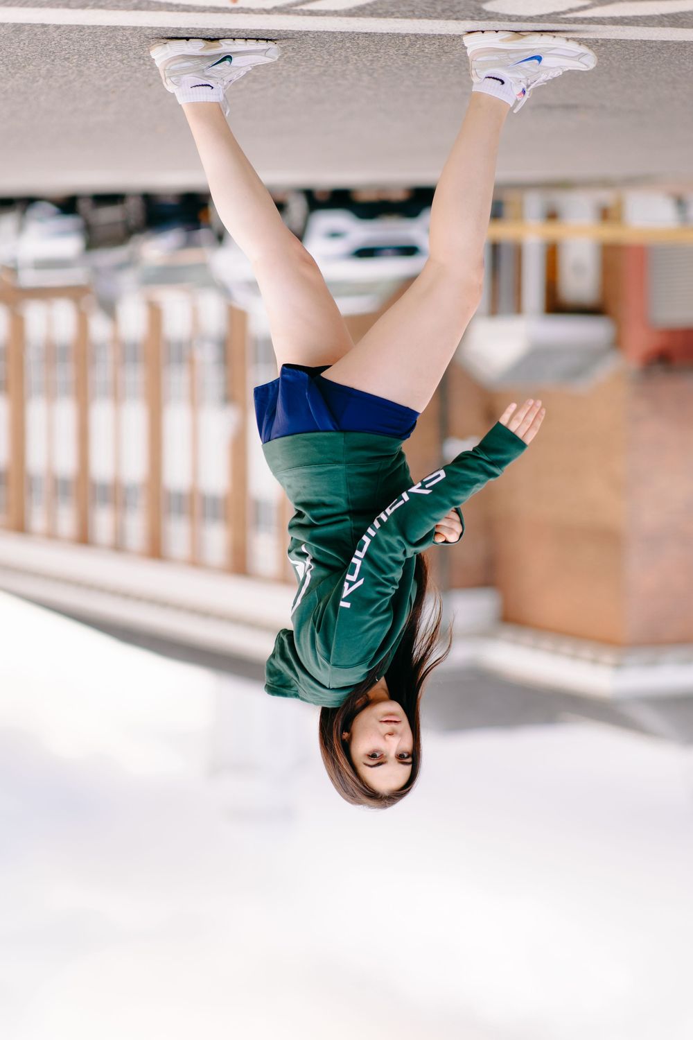 A gymnast performing a series of handstand poses on white flooring, shown in sequential action shots.
