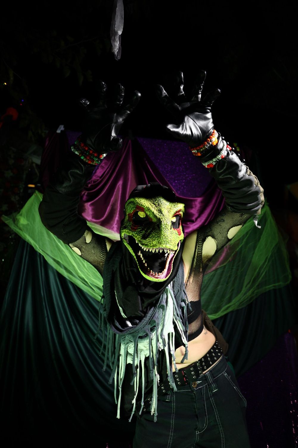 A dramatic cosplay photo sequence showing a witch character with green and purple clothing against a dark background.