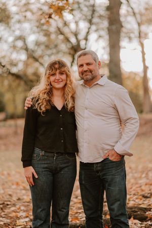 Family portrait session showing candid moments and interactions in a fall setting with trees.