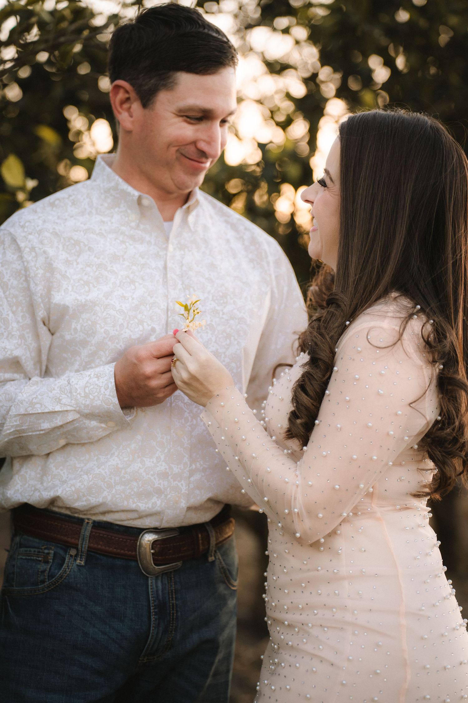Intimate moments captured between couple in white clothing during outdoor photoshoot.