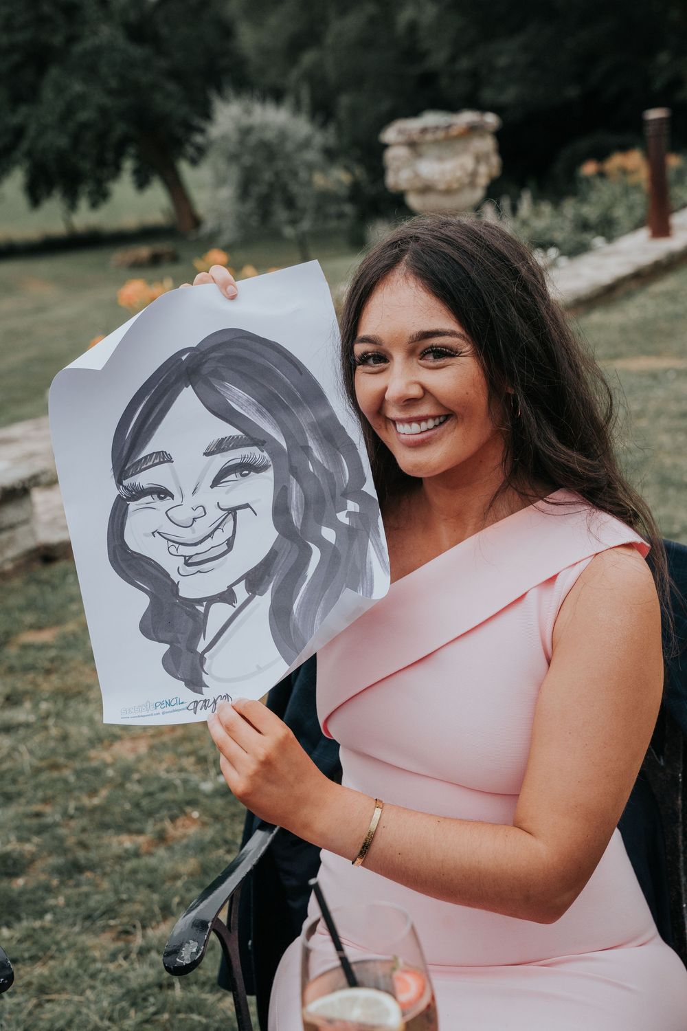 Caricaturist from Sensible Pencil drawing wedding guests outdoors